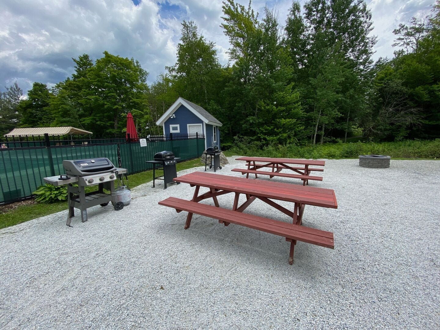 Propane BBQ grills and picnic tables available for guest use near outdoor pool at Mountain Green vacation rental condos