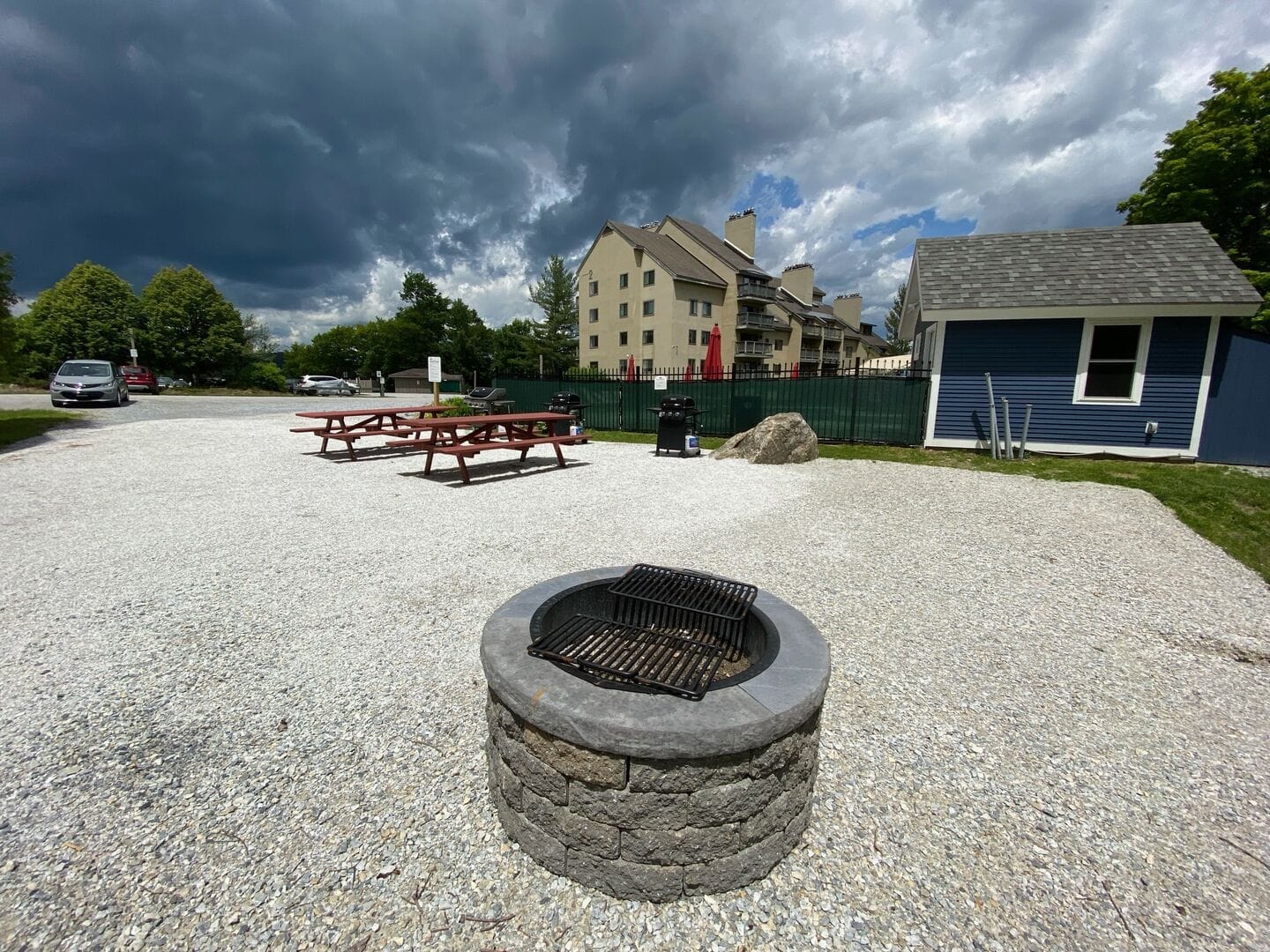Stone fire pit with Adirondack chairs and evening seating area at Mountain Green Resort