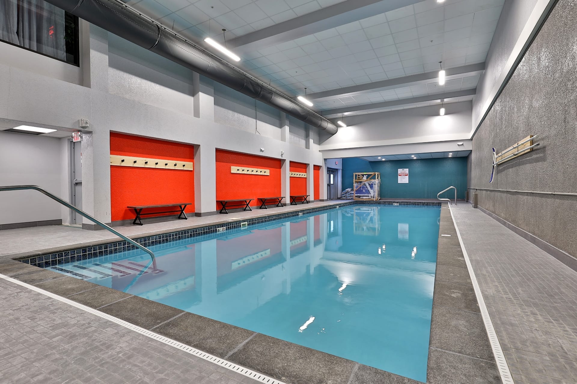 Indoor heated saltwater swimming pool with lounge furniture and natural light at Mountain Green Resort