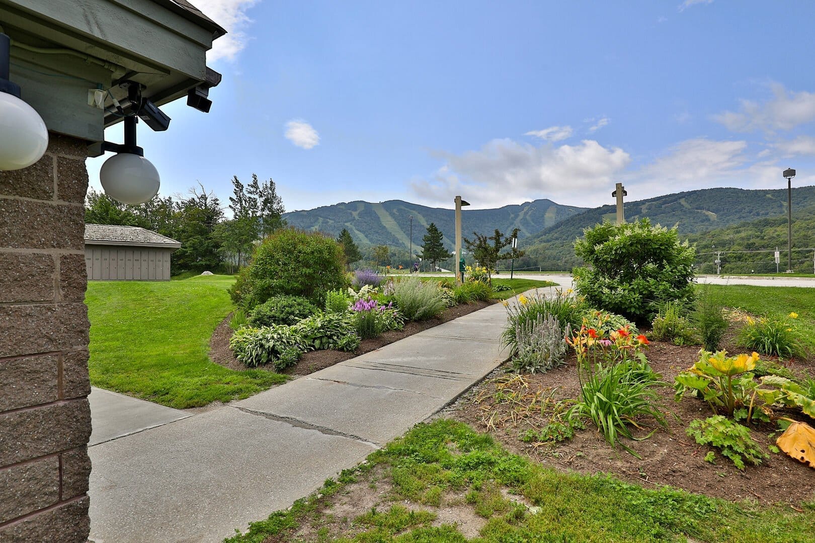 Landscaped resort grounds with seasonal flowers, lawns, and mountain views at Mountain Green Killington