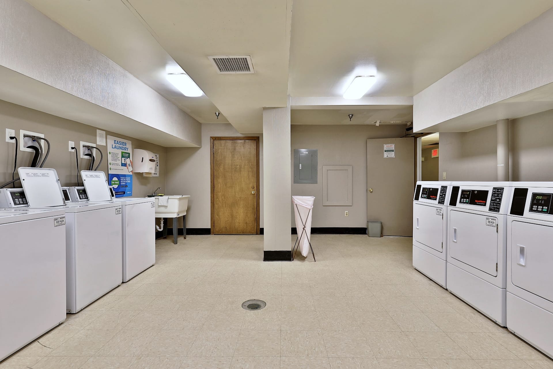 Modern on-site laundry facilities with commercial washers and dryers, app payment system in each building at Mountain Green condos